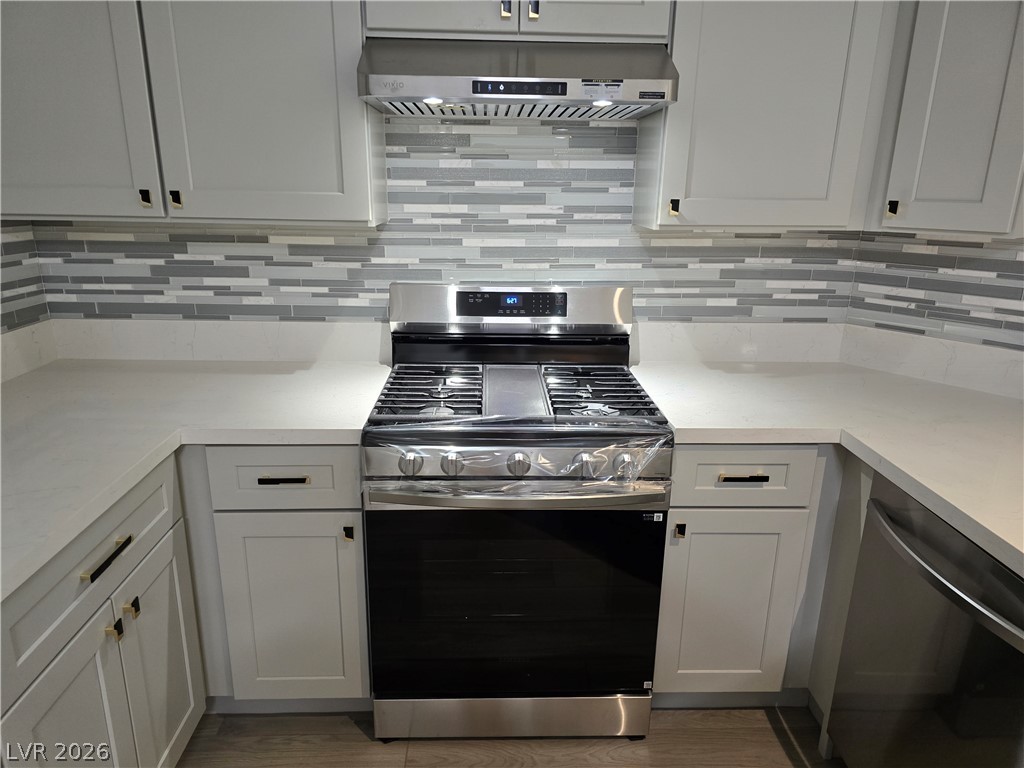 1881 West Alexander Road, Unit 1127 North Las Vegas, NV 89032 - Photo 3 of 20 A well-appointed kitchen showcasing a sleek gas range and contemporary backsplash.