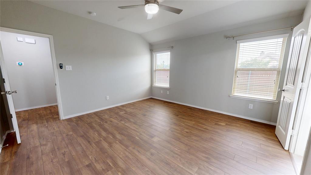 3101 Buckthorn Street Forney, TX 75126 - Photo 14 of 40 Spacious room featuring wood-finish flooring, vaulted ceiling, and a ceiling fan with integrated lighting