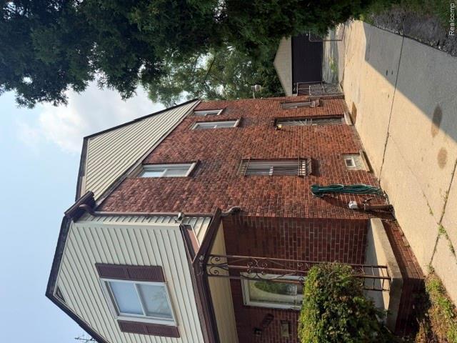 8144 Meyers Road Detroit, MI 48228 - Photo 2 of 19 Brick exterior with light-toned siding accents, featuring a covered front porch with decorative metal supports