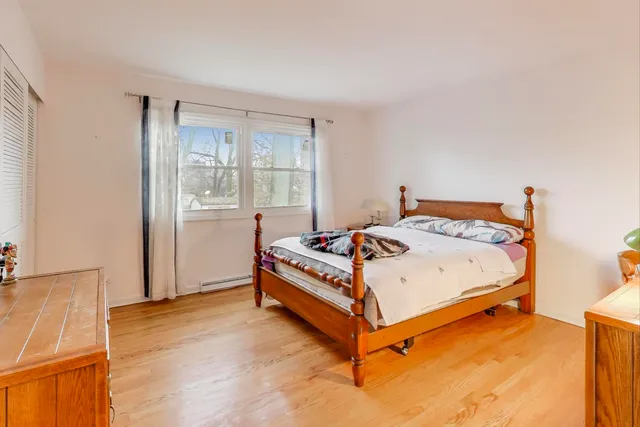 a bed sitting in a bedroom next to a window