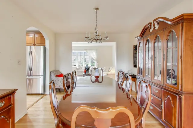 a view of a dining room with furniture and a chandelier