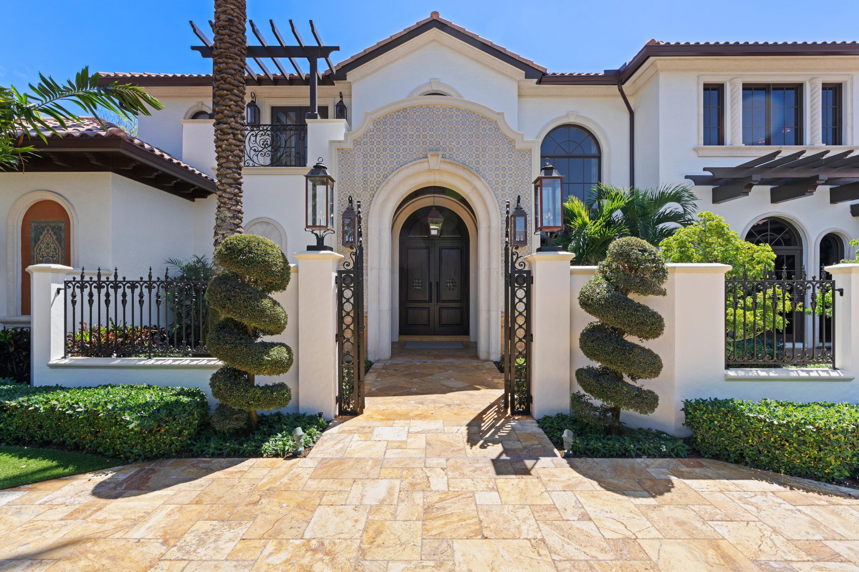 166 Alexander Palm Road Boca Raton, FL 33432 - Photo 25 of 122 a front view of a house with a garden