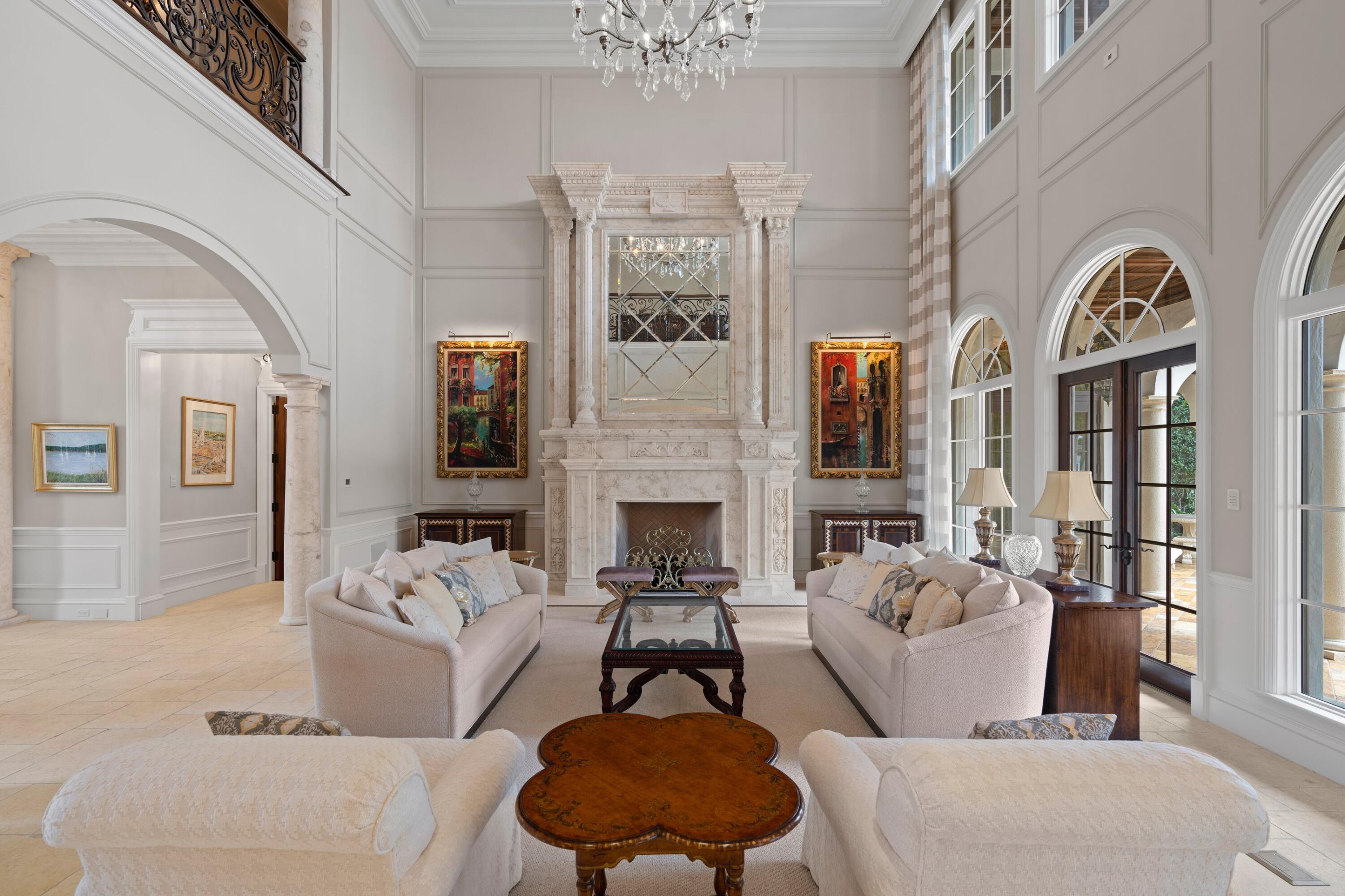 166 Alexander Palm Road Boca Raton, FL 33432 - Photo 32 of 122 a living room with furniture fireplace and a chandelier