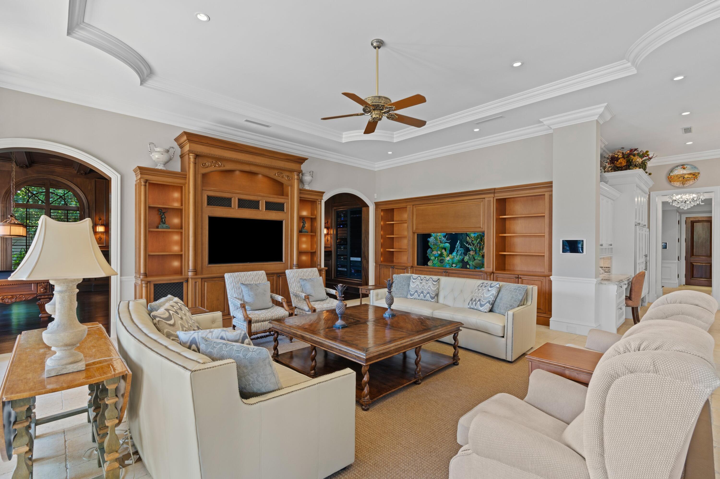 166 Alexander Palm Road Boca Raton, FL 33432 - Photo 49 of 122 a living room with furniture a flat screen tv and a large window
