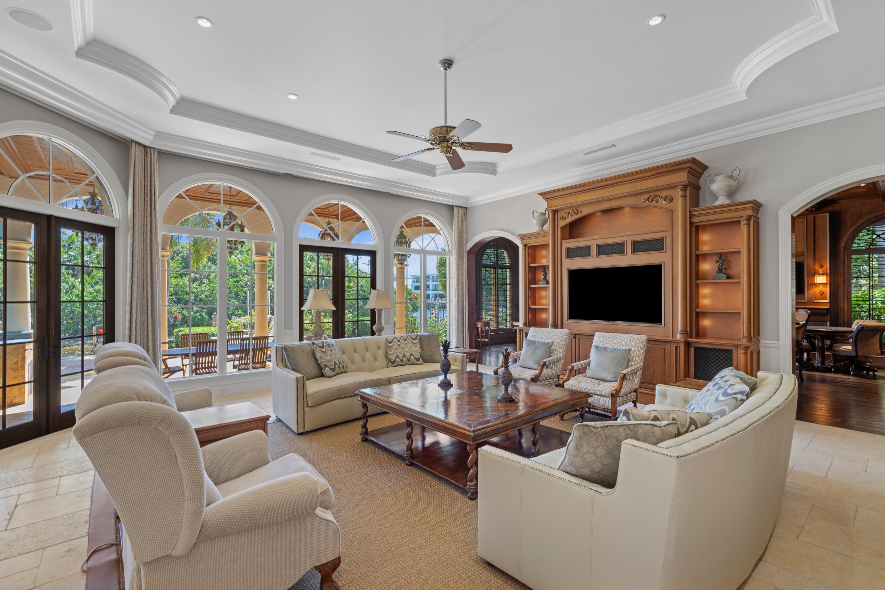 166 Alexander Palm Road Boca Raton, FL 33432 - Photo 51 of 122 a living room with furniture a chandelier and a large window