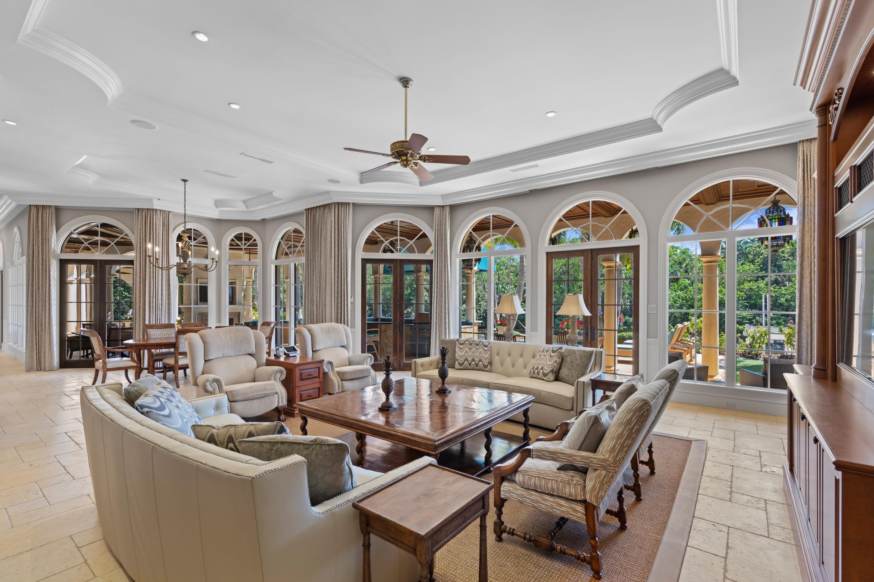 166 Alexander Palm Road Boca Raton, FL 33432 - Photo 52 of 122 a view of a livingroom with furniture large windows a livingroom and chandelier