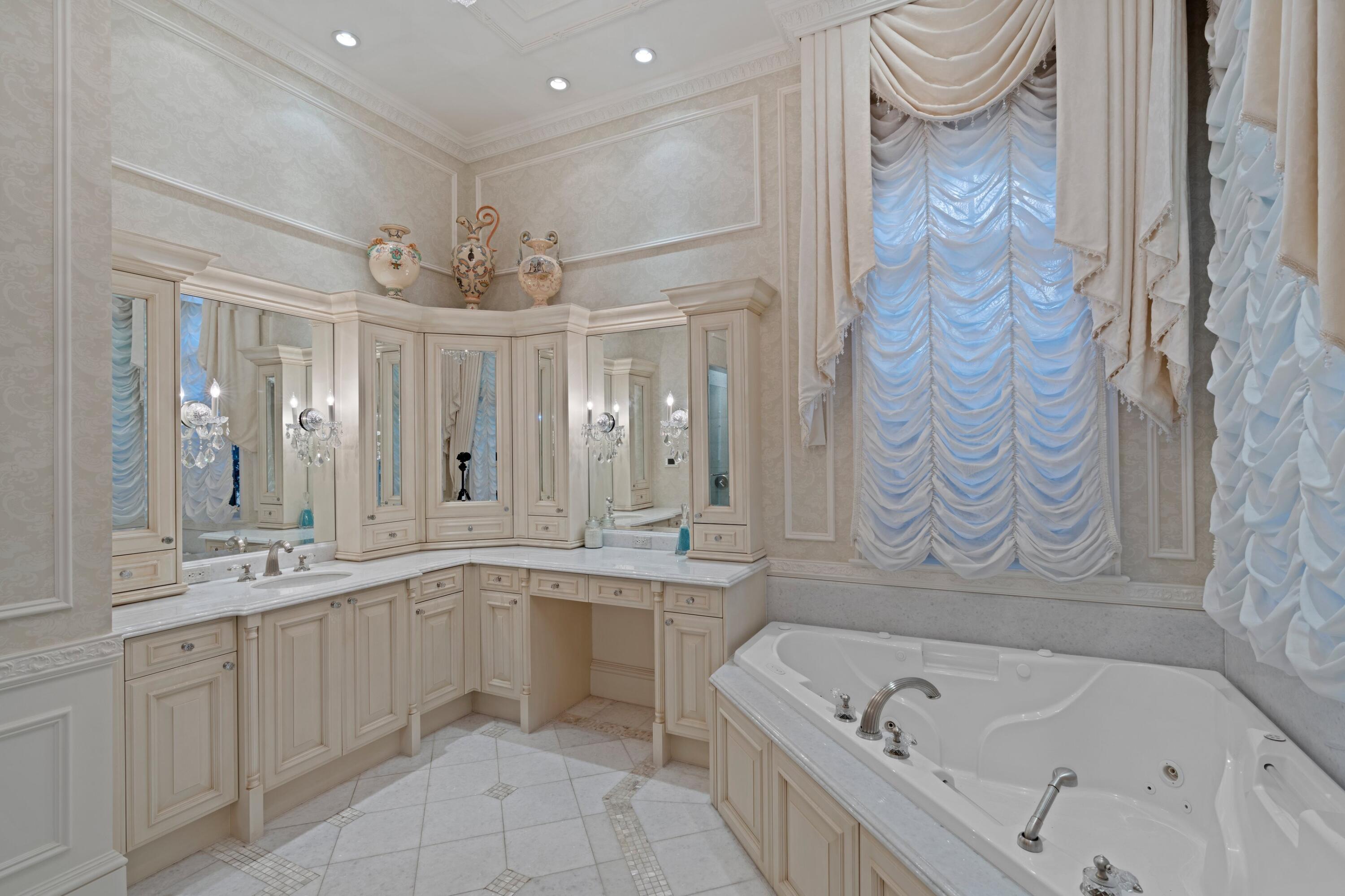 166 Alexander Palm Road Boca Raton, FL 33432 - Photo 63 of 122 a bathroom with a bathtub a sink a vanity and a shower
