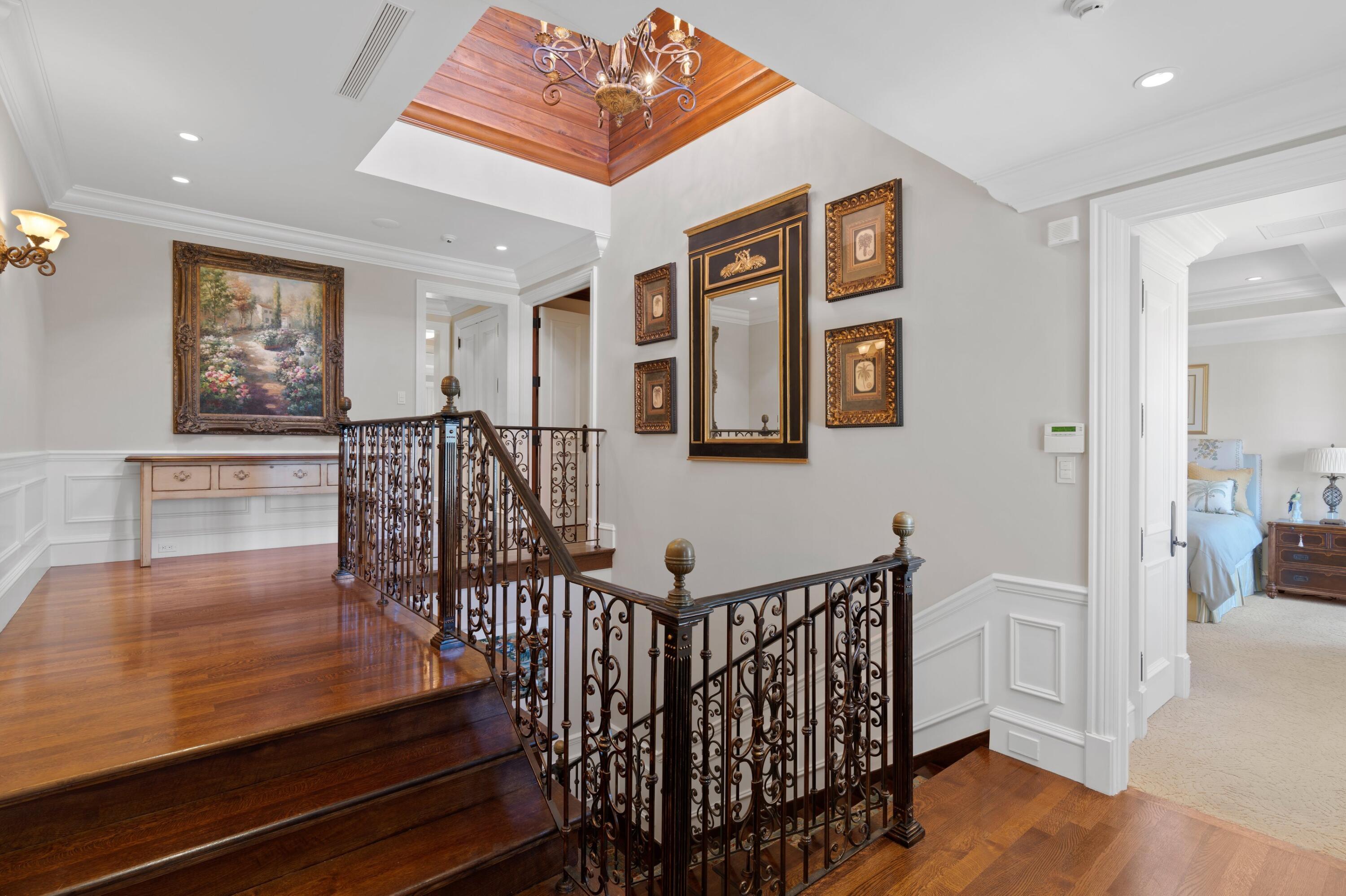 166 Alexander Palm Road Boca Raton, FL 33432 - Photo 100 of 122 a view of a hallway with wooden floor and windows