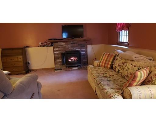 29 Walton Road Harwich, MA 02645 - Photo 17 of 23 a living room with furniture a flat screen tv and a fireplace