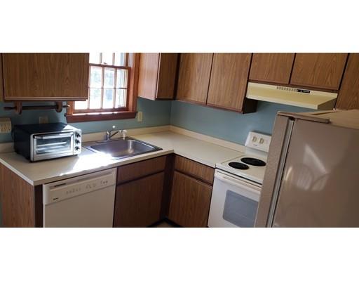 29 Walton Road Harwich, MA 02645 - Photo 7 of 23 a kitchen with kitchen island a sink a stove and wooden cabinets