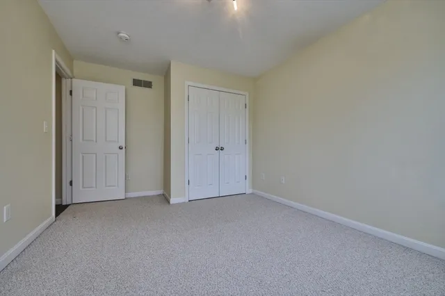 an empty room with closet area