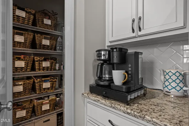 a kitchen with stainless steel appliances kitchen island granite countertop a stove and refrigerator