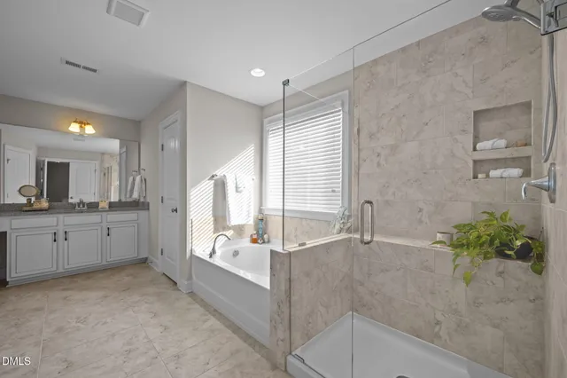 a view of walk in closet with clothes