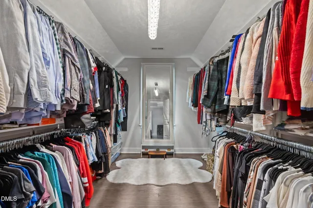 a spacious bathroom with a toilet sink and mirror