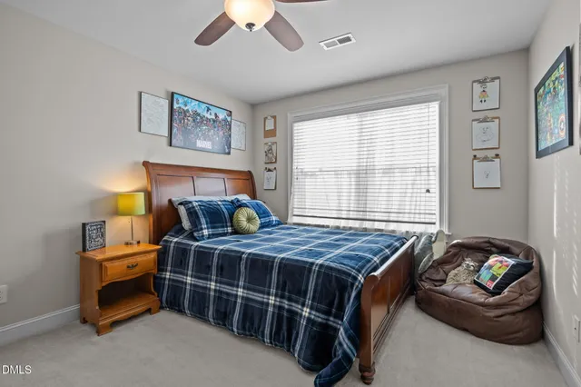 a bedroom with furniture and a large window