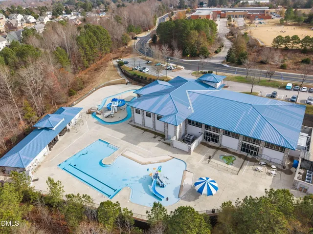 an aerial view of a house with yard glass top table and chairs