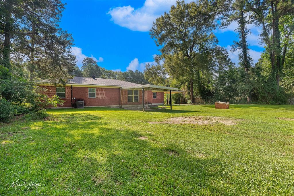 9342 Dean Road Shreveport, LA 71118 - Photo 16 of 18 Spacious green lawn surrounding a red brick residence with a covered patio area