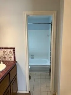 a bathroom with a bathtub and a sink