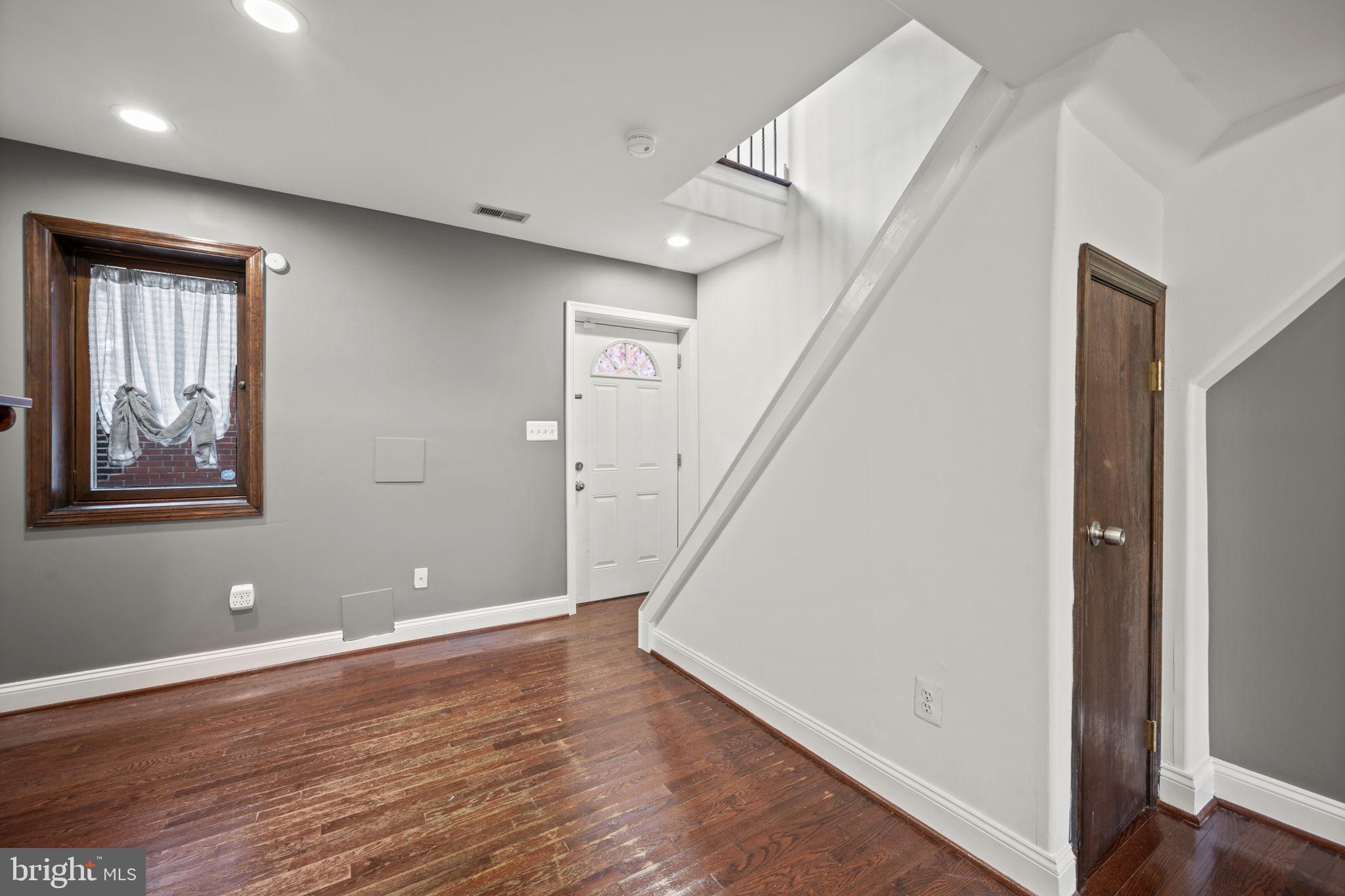 413 Griffin Court Baltimore, MD 21231 - Photo 17 of 37 a view of room with window and wooden floor