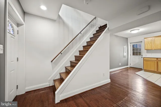 a kitchen with a refrigerator and a stove top oven