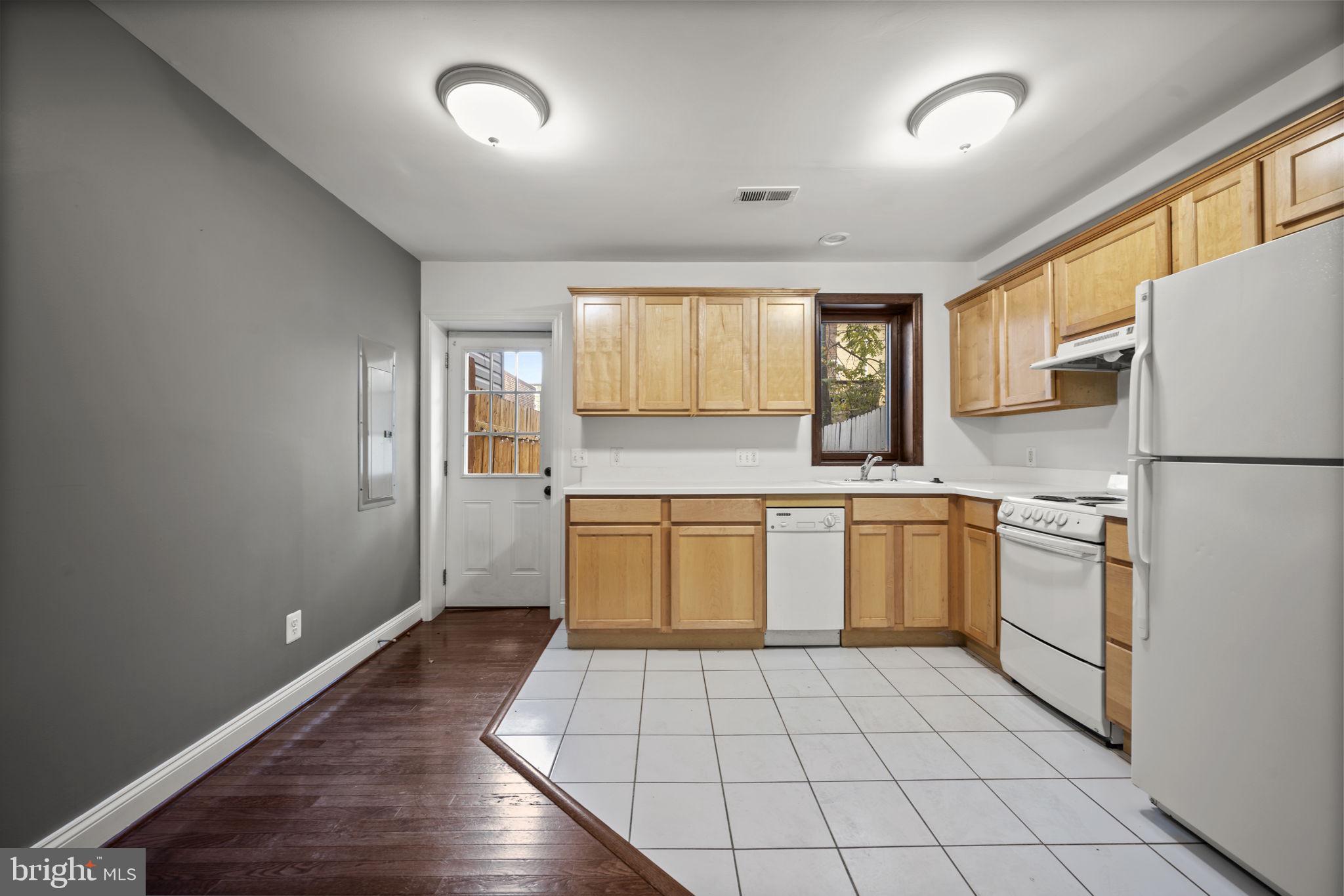 413 Griffin Court Baltimore, MD 21231 - Photo 19 of 37 a kitchen with a refrigerator and a stove top oven
