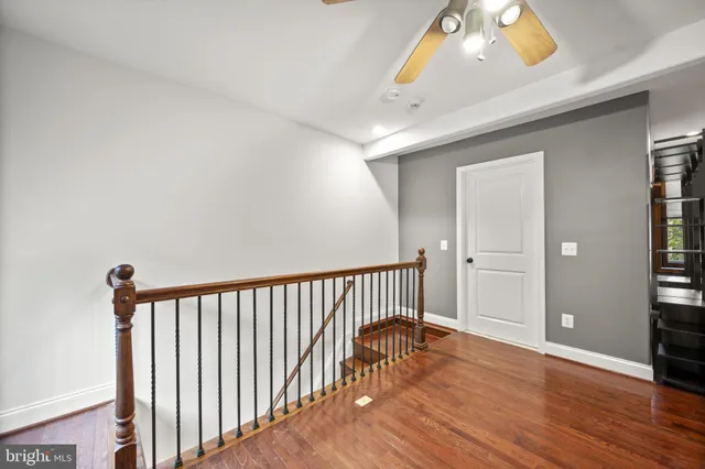 a view of a livingroom with wooden floor and a window