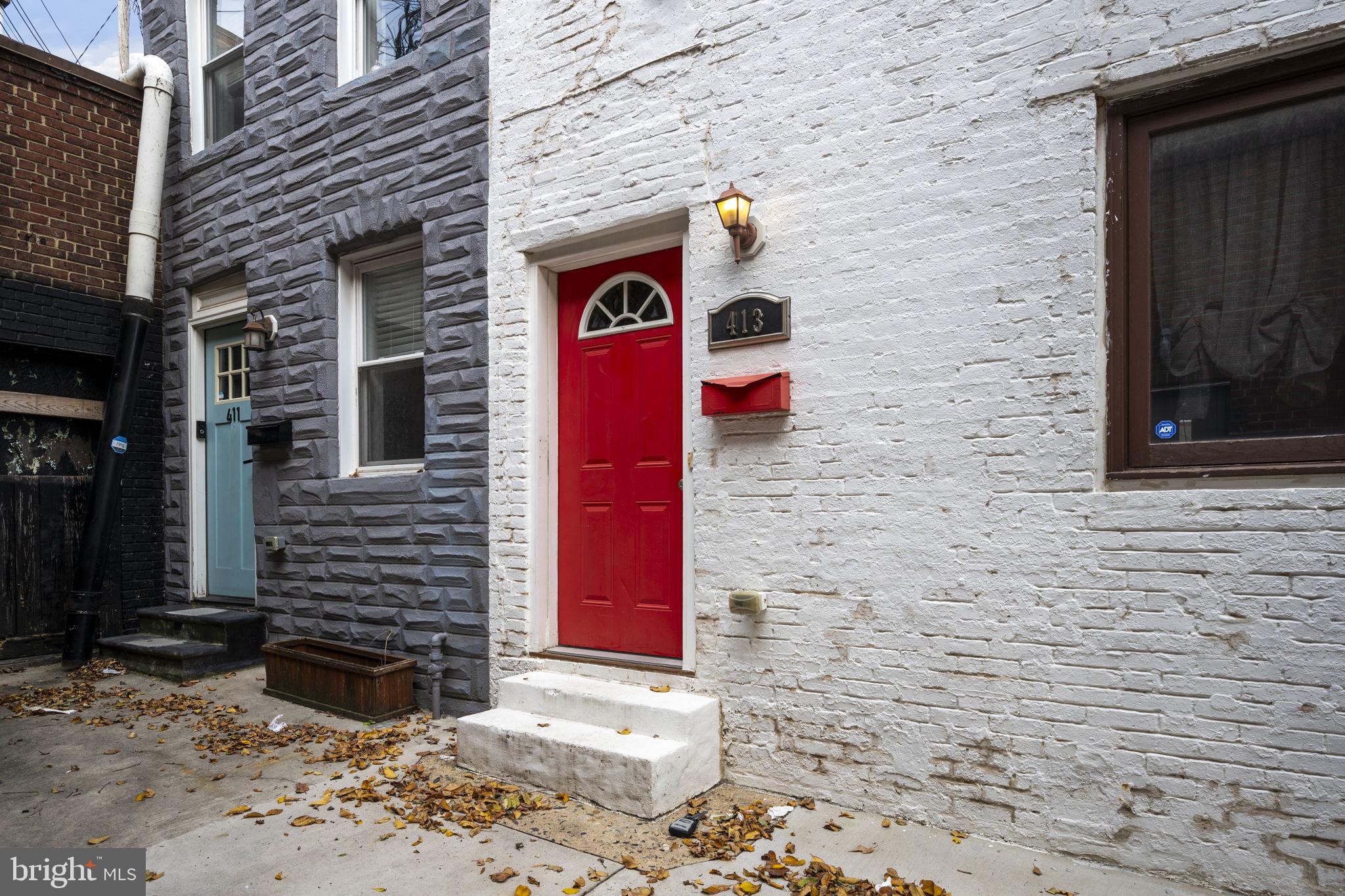 413 Griffin Court Baltimore, MD 21231 - Photo 2 of 37 a front view of a house with a yard