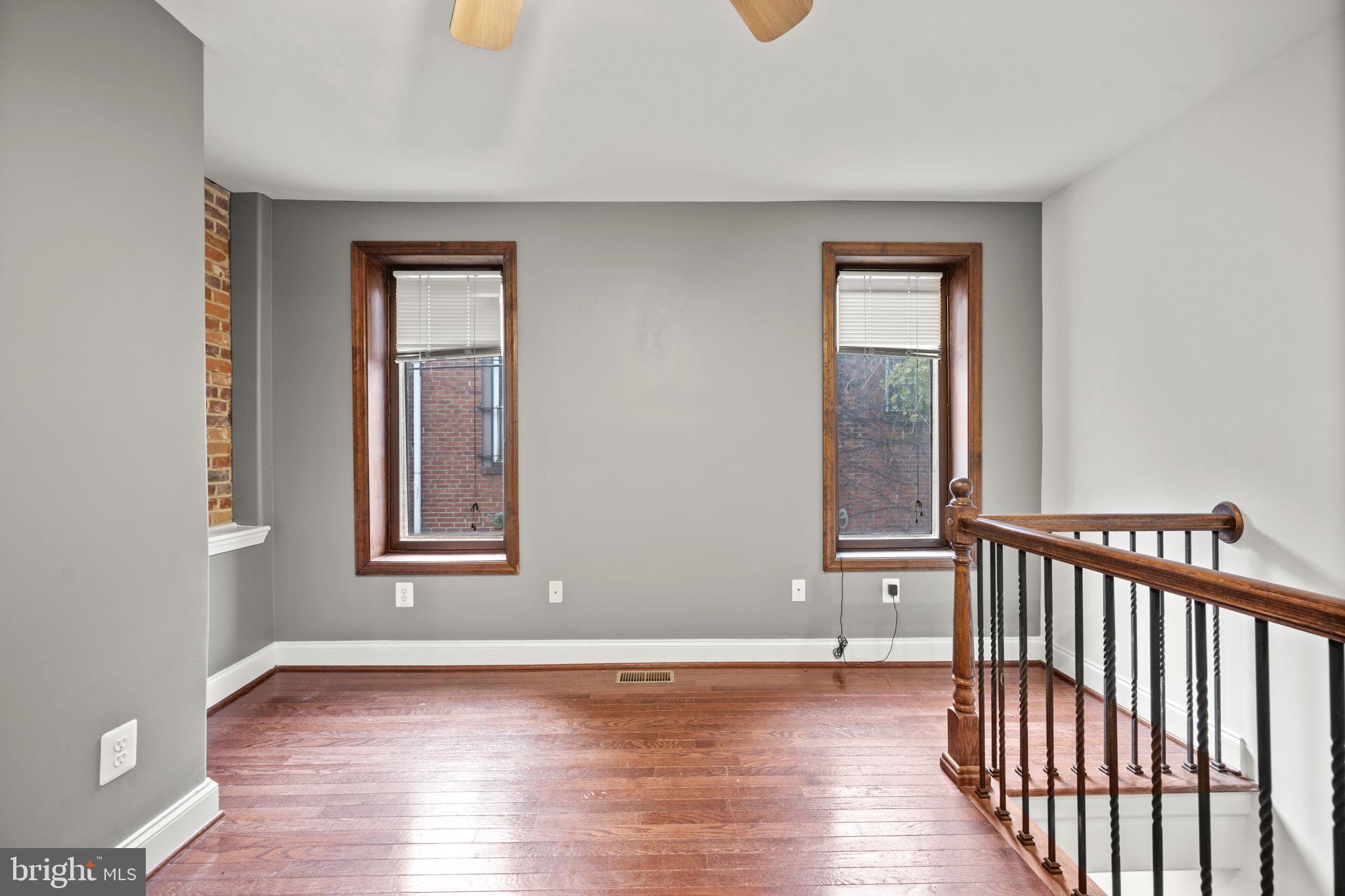 413 Griffin Court Baltimore, MD 21231 - Photo 21 of 37 a view of a livingroom with wooden floor and a window