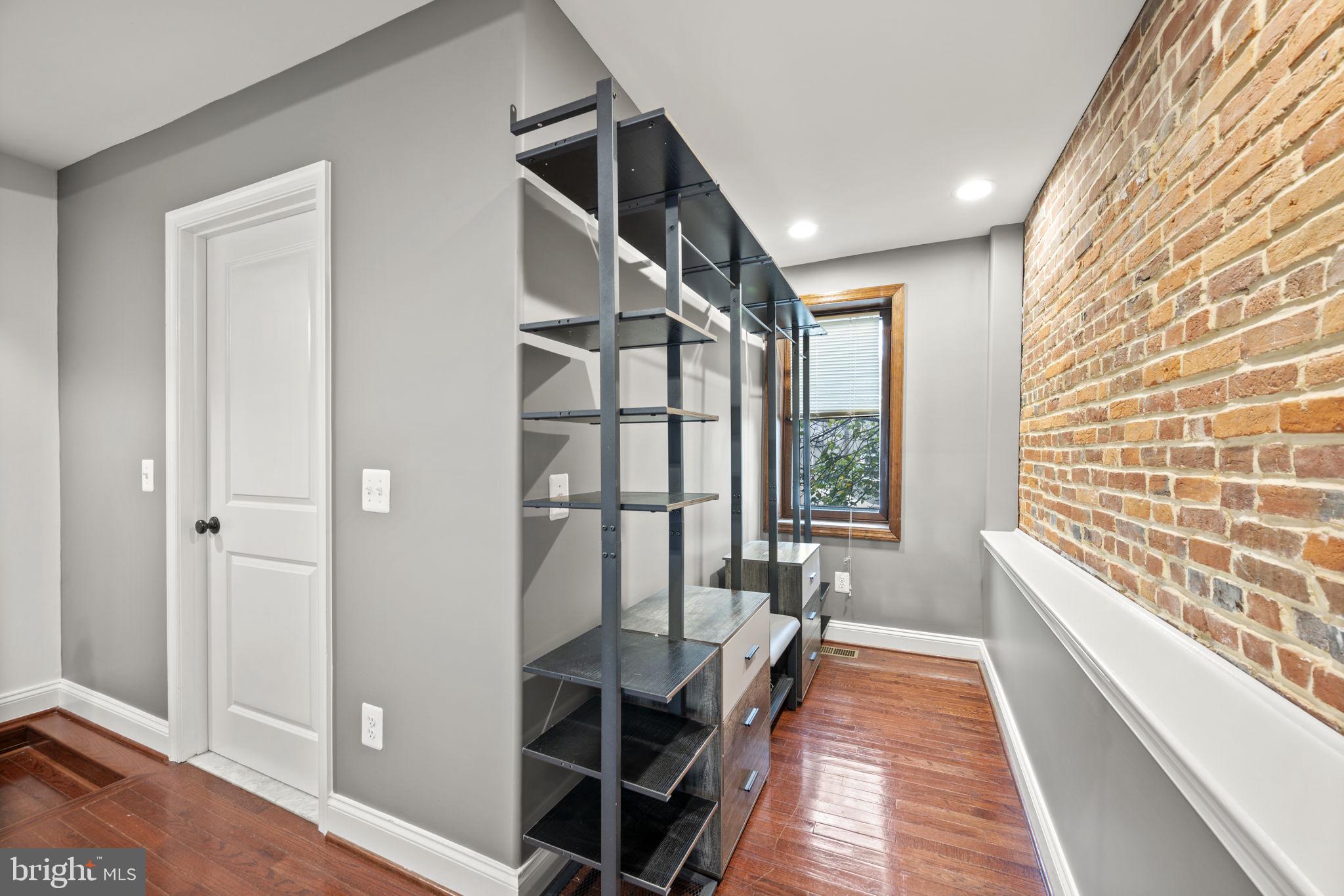 413 Griffin Court Baltimore, MD 21231 - Photo 26 of 37 a hallway with a large window and wooden floor