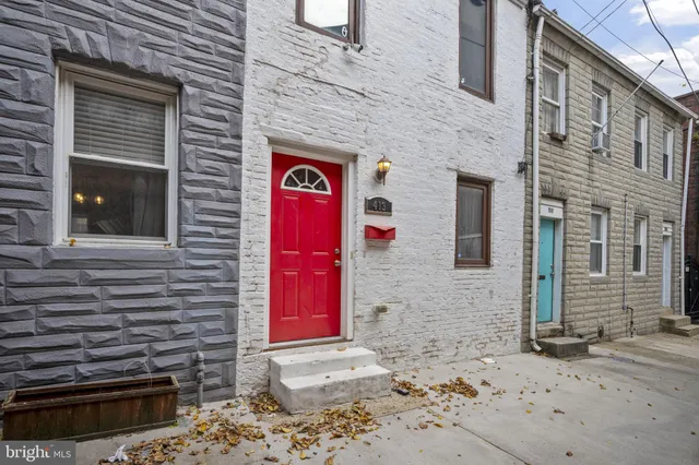 a front view of a building with a brick wall