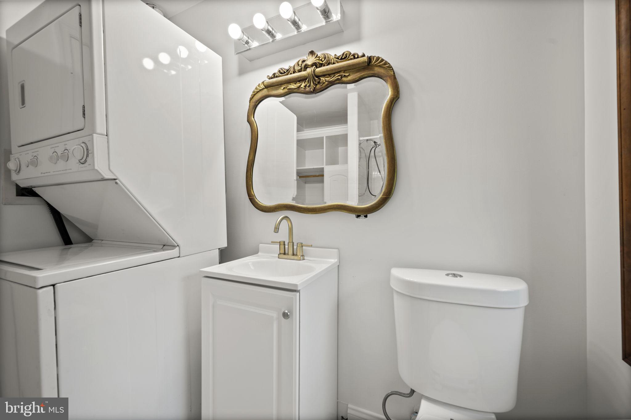 413 Griffin Court Baltimore, MD 21231 - Photo 31 of 37 a bathroom with a toilet sink and mirror