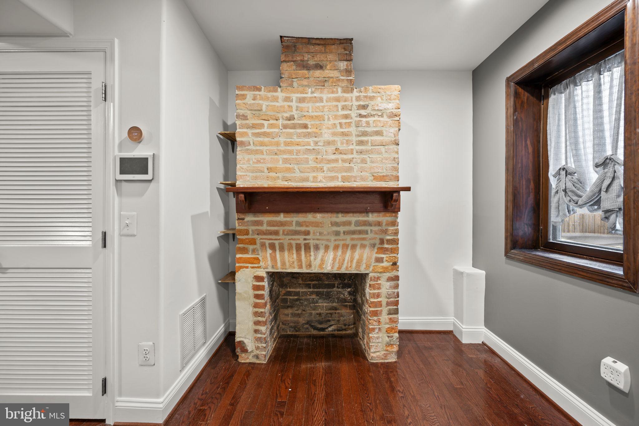 413 Griffin Court Baltimore, MD 21231 - Photo 8 of 37 a view of an empty room with wooden floor and a window