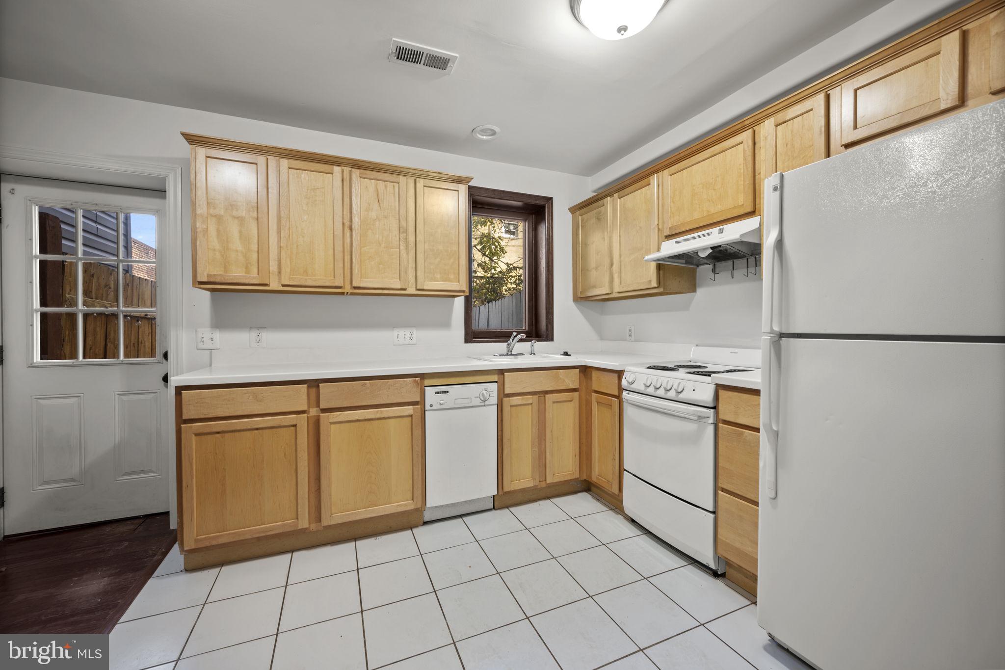 413 Griffin Court Baltimore, MD 21231 - Photo 9 of 37 a kitchen with stainless steel appliances granite countertop a refrigerator sink and cabinets