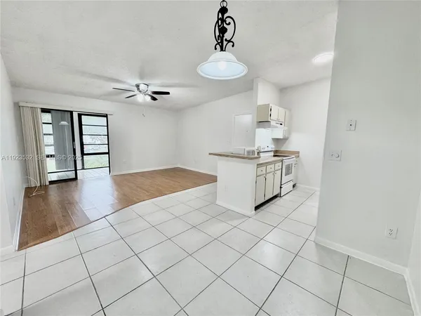 a view of a livingroom with wooden floor and chandelier