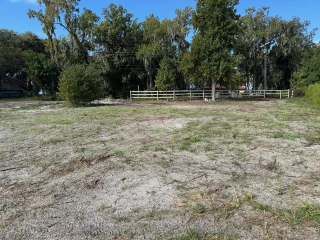 a view of outdoor space with green field and trees