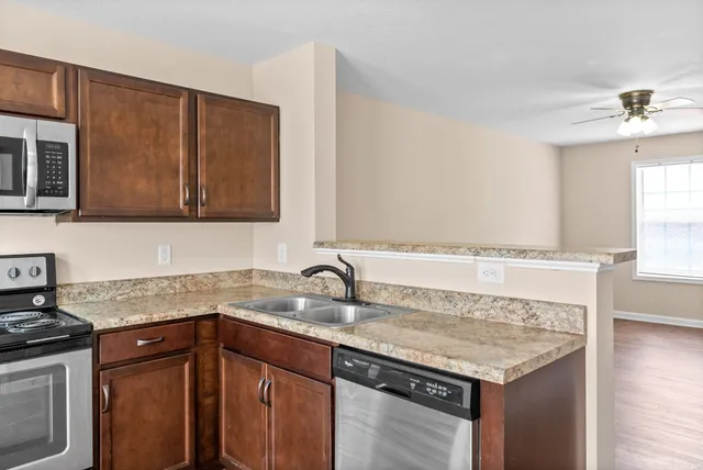 a kitchen with granite countertop a sink and cabinets