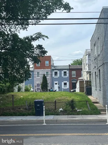 a view of a big building next to a yard