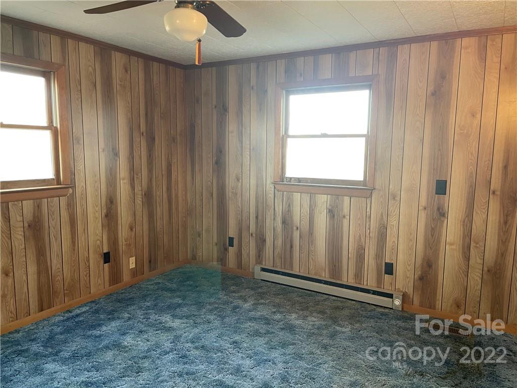 341 Walls Church Road Bostic, NC 28018 - Photo 20 of 24 an empty room with windows chandelier fan and windows