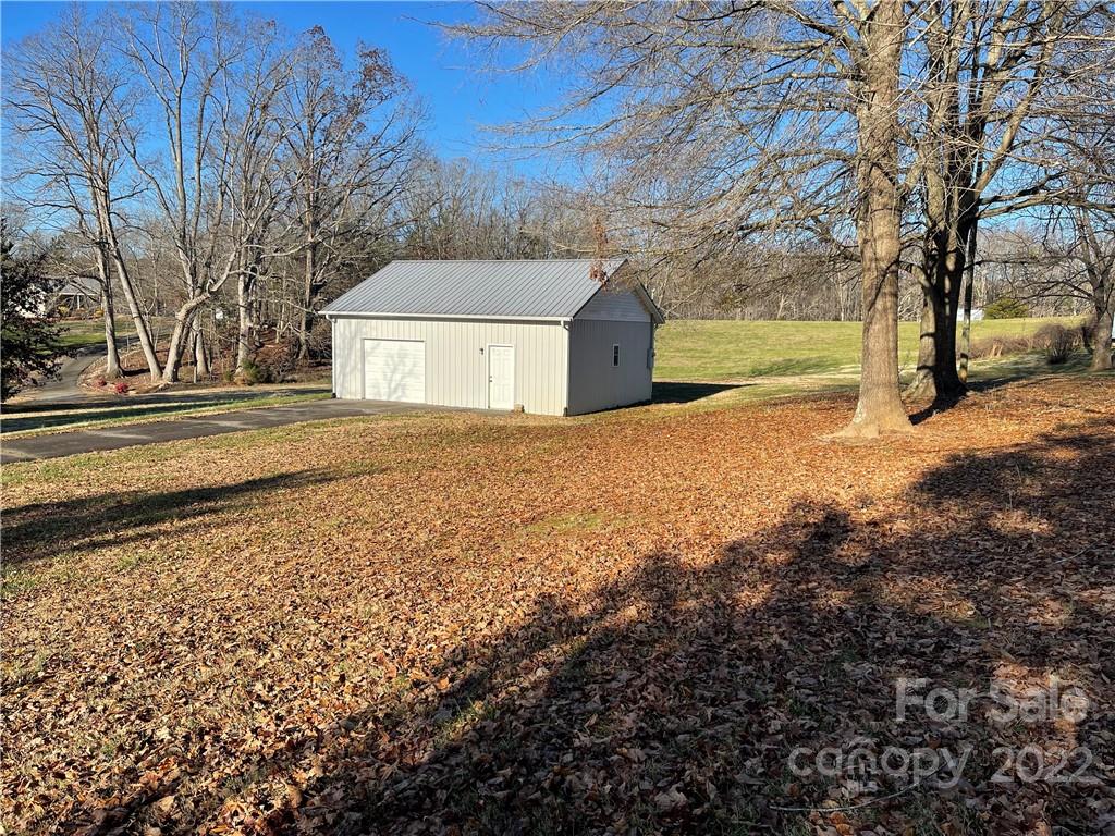 341 Walls Church Road Bostic, NC 28018 - Photo 6 of 24 a front view of a house with a yard and large trees