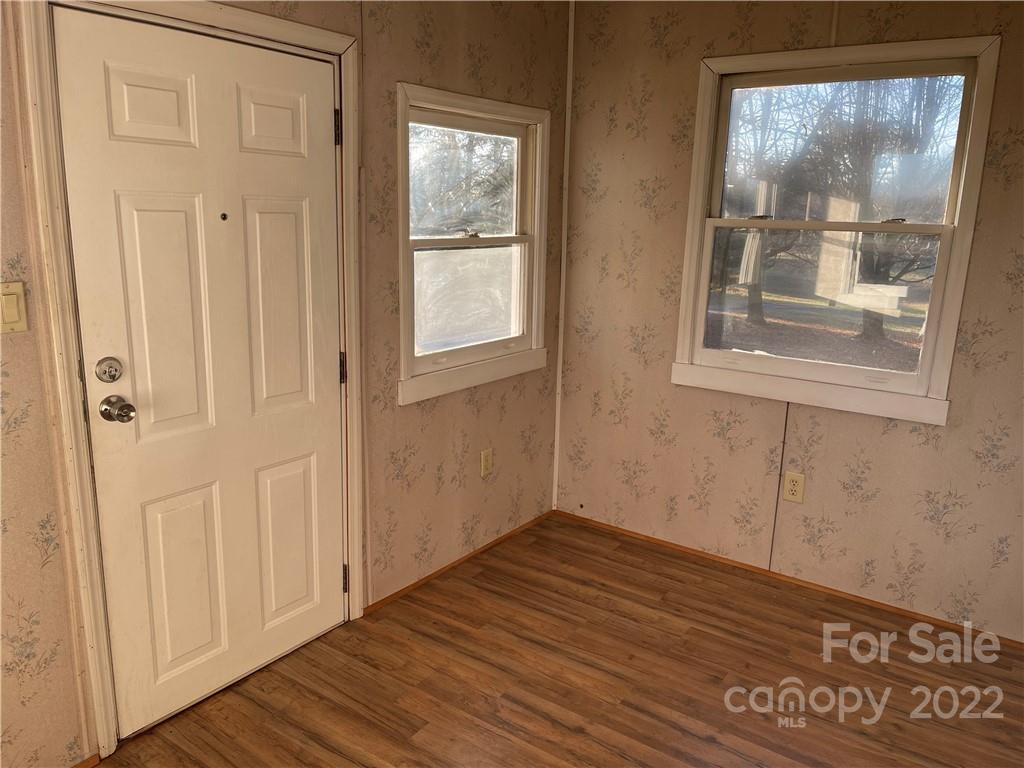 341 Walls Church Road Bostic, NC 28018 - Photo 8 of 24 a view of an empty room with wooden floor and a window
