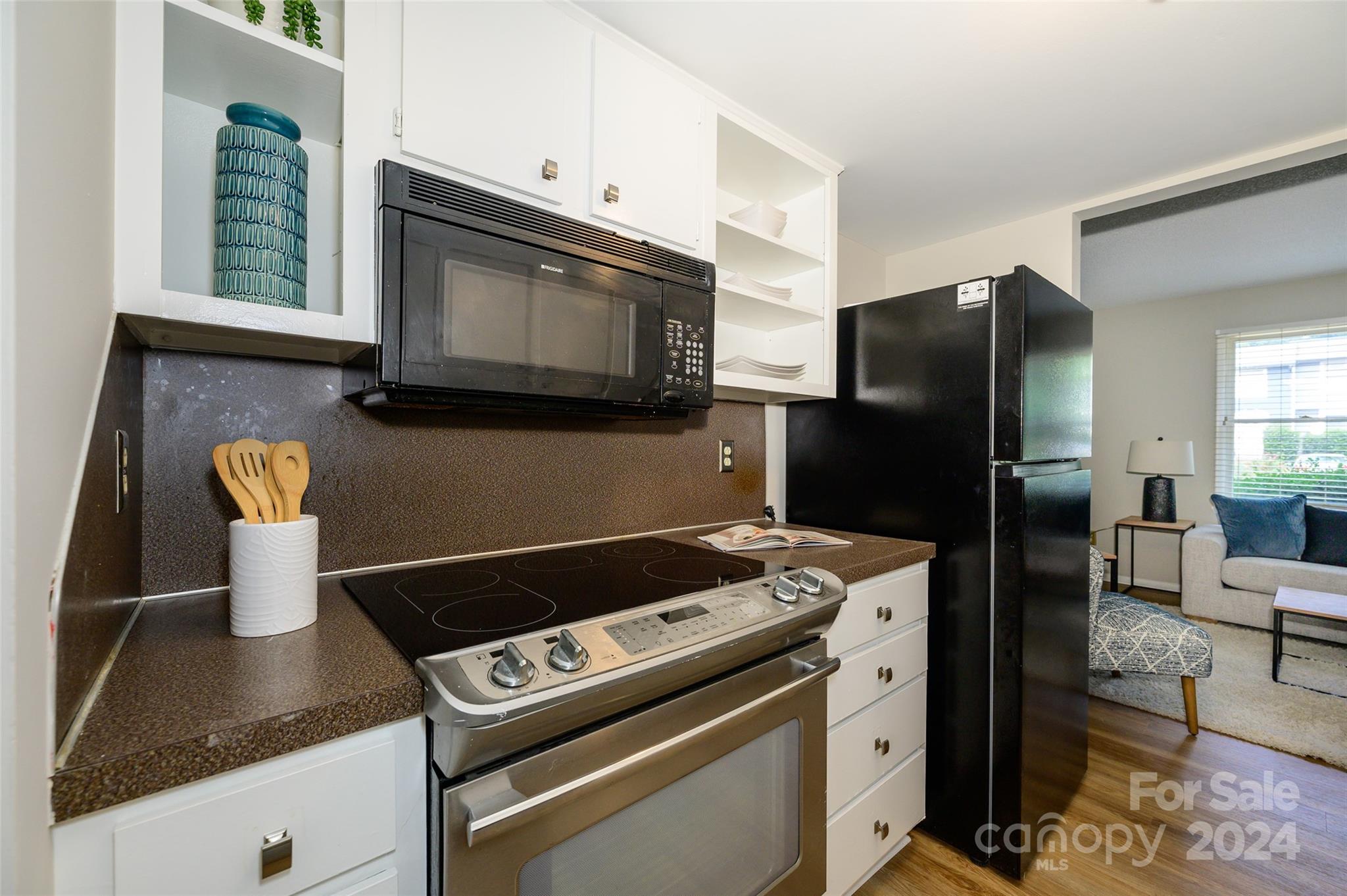 1211 Scaleybark Road, Unit B Charlotte, NC 28209 - Photo 12 of 30 a kitchen with a stove and a microwave