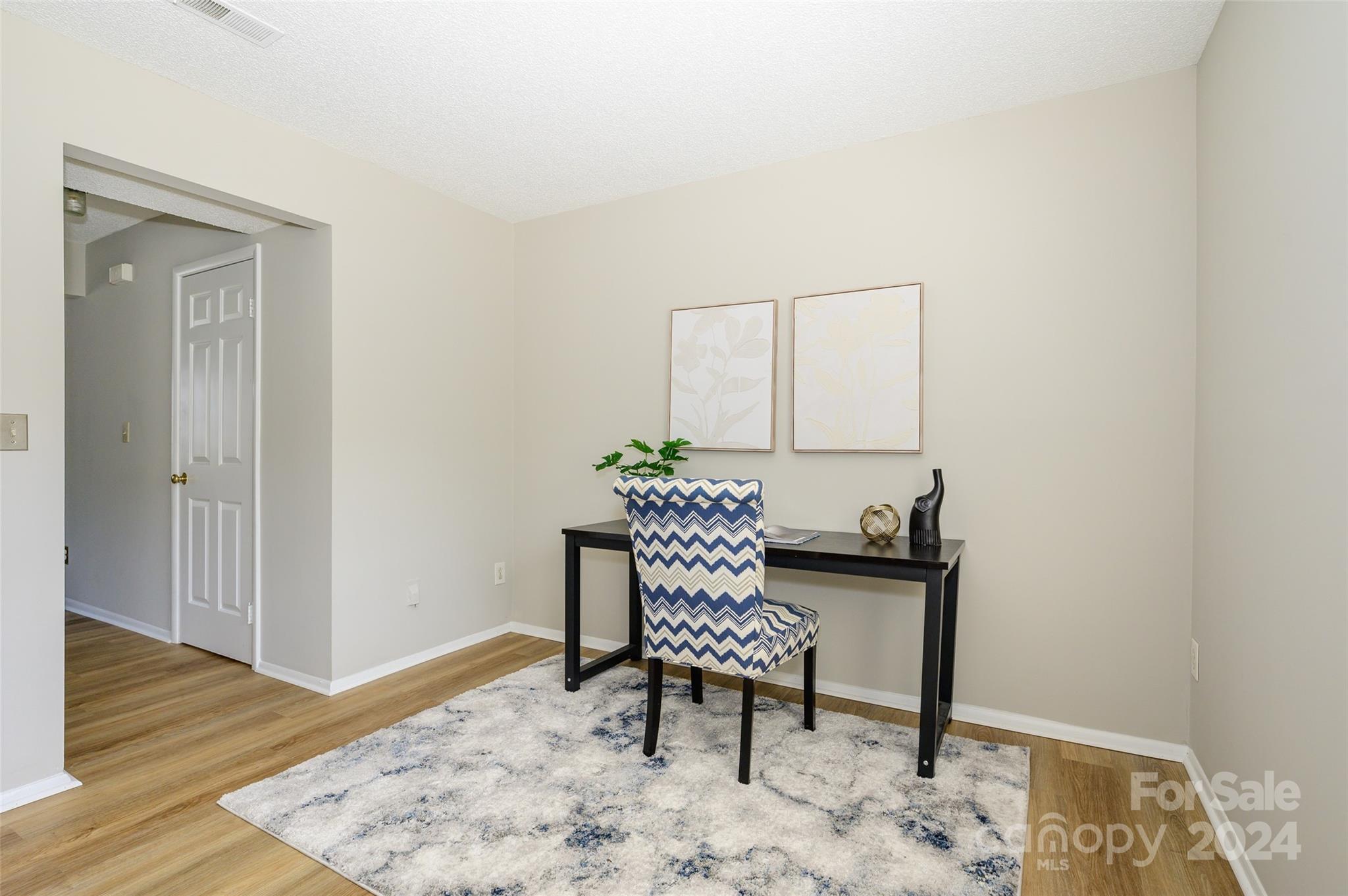 1211 Scaleybark Road, Unit B Charlotte, NC 28209 - Photo 17 of 30 a view of a workspace with furniture and wooden floor