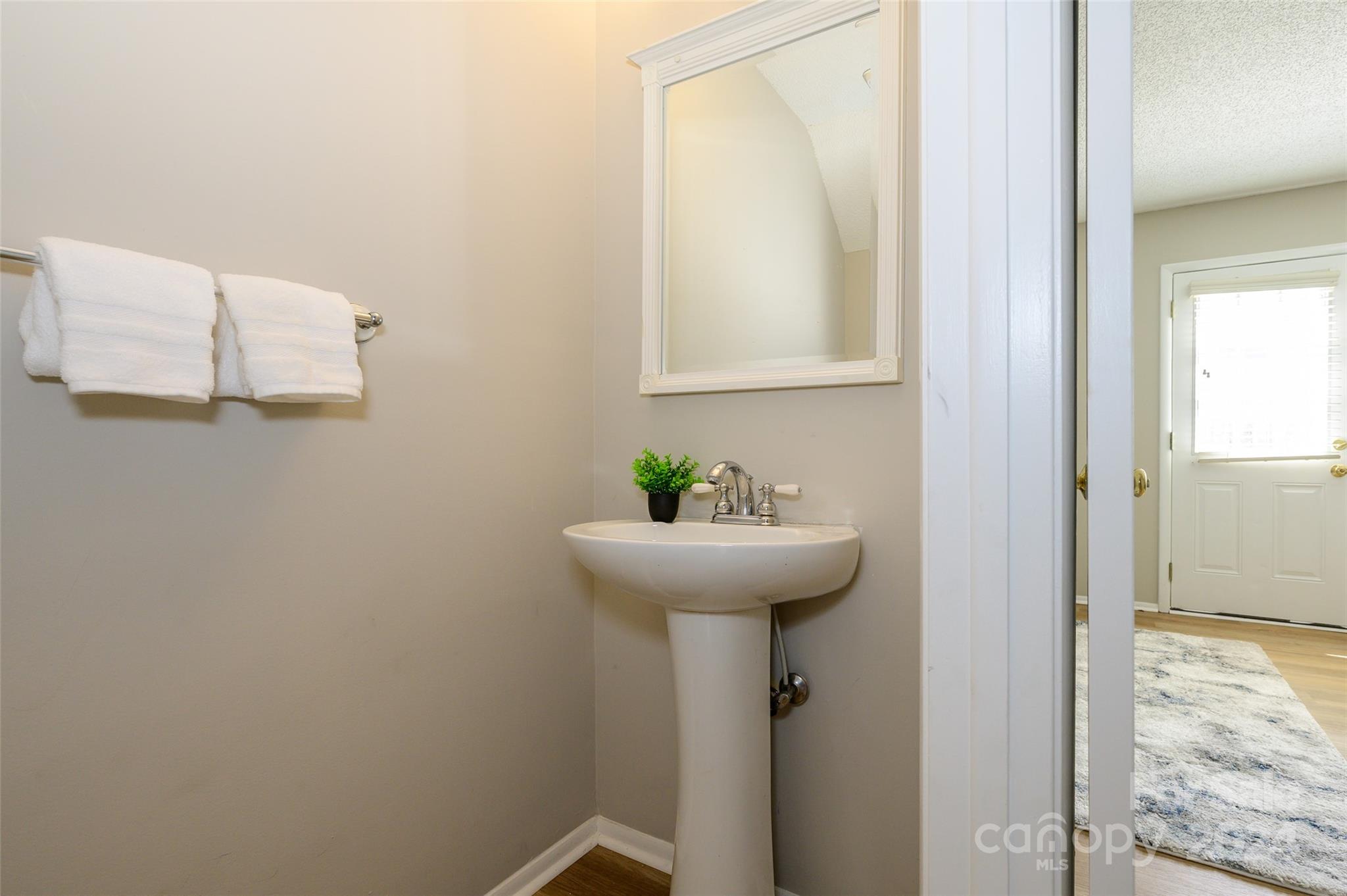 1211 Scaleybark Road, Unit B Charlotte, NC 28209 - Photo 18 of 30 a bathroom with a sink and a mirror