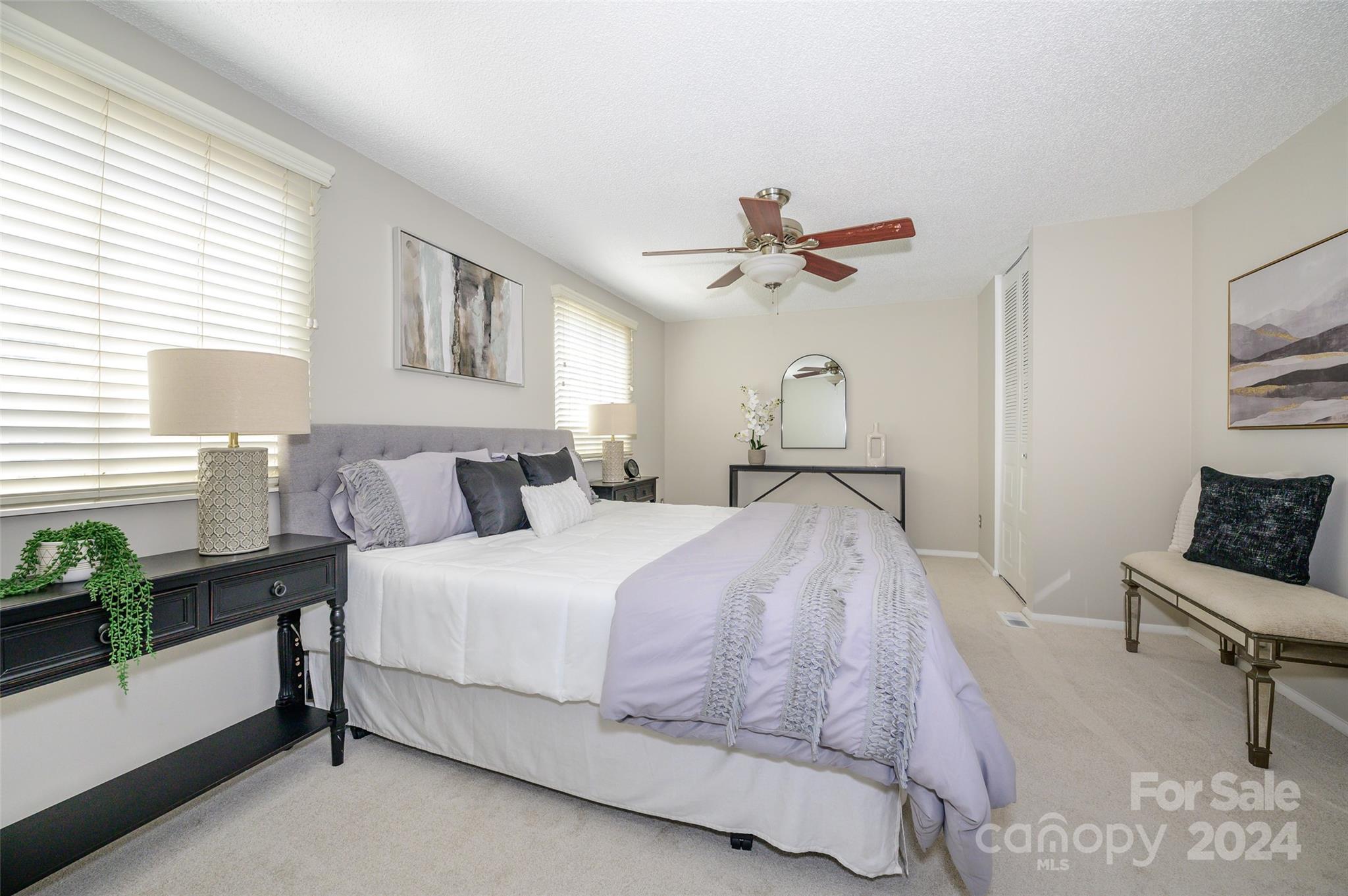 1211 Scaleybark Road, Unit B Charlotte, NC 28209 - Photo 20 of 30 a spacious bedroom with a bed and a chandelier
