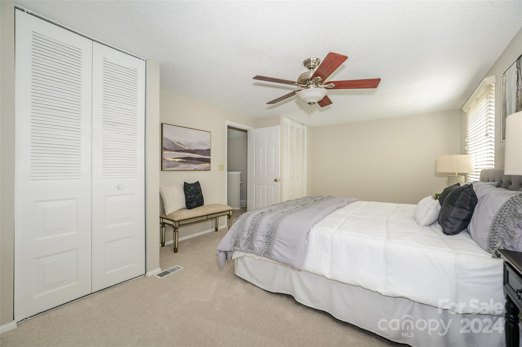 1211 Scaleybark Road, Unit B Charlotte, NC 28209 - Photo 21 of 30 a bedroom with a bed and a chandelier
