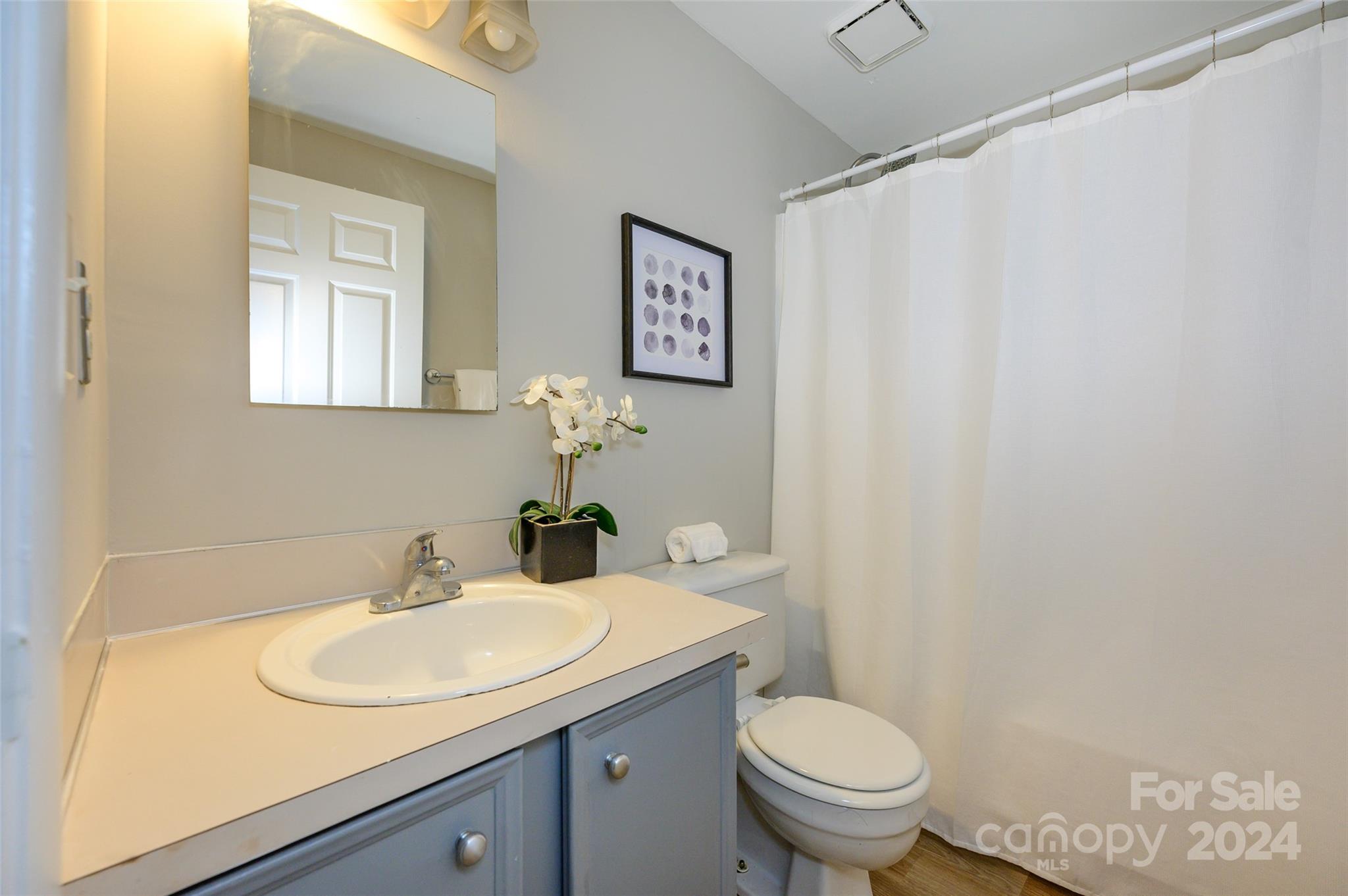 1211 Scaleybark Road, Unit B Charlotte, NC 28209 - Photo 22 of 30 a bathroom with a granite countertop sink and a toilet