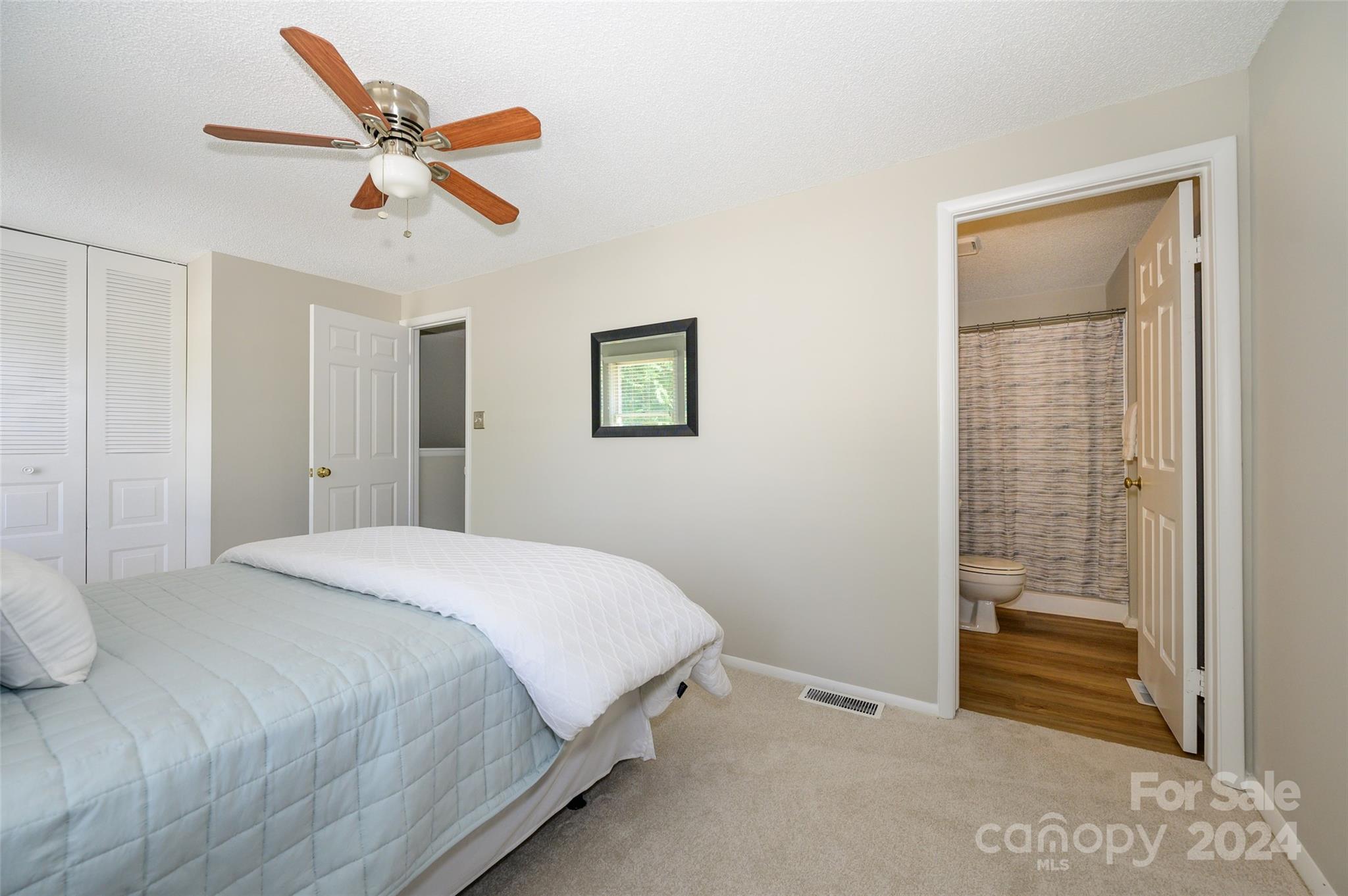 1211 Scaleybark Road, Unit B Charlotte, NC 28209 - Photo 25 of 30 a bedroom with a large bed and a chandelier