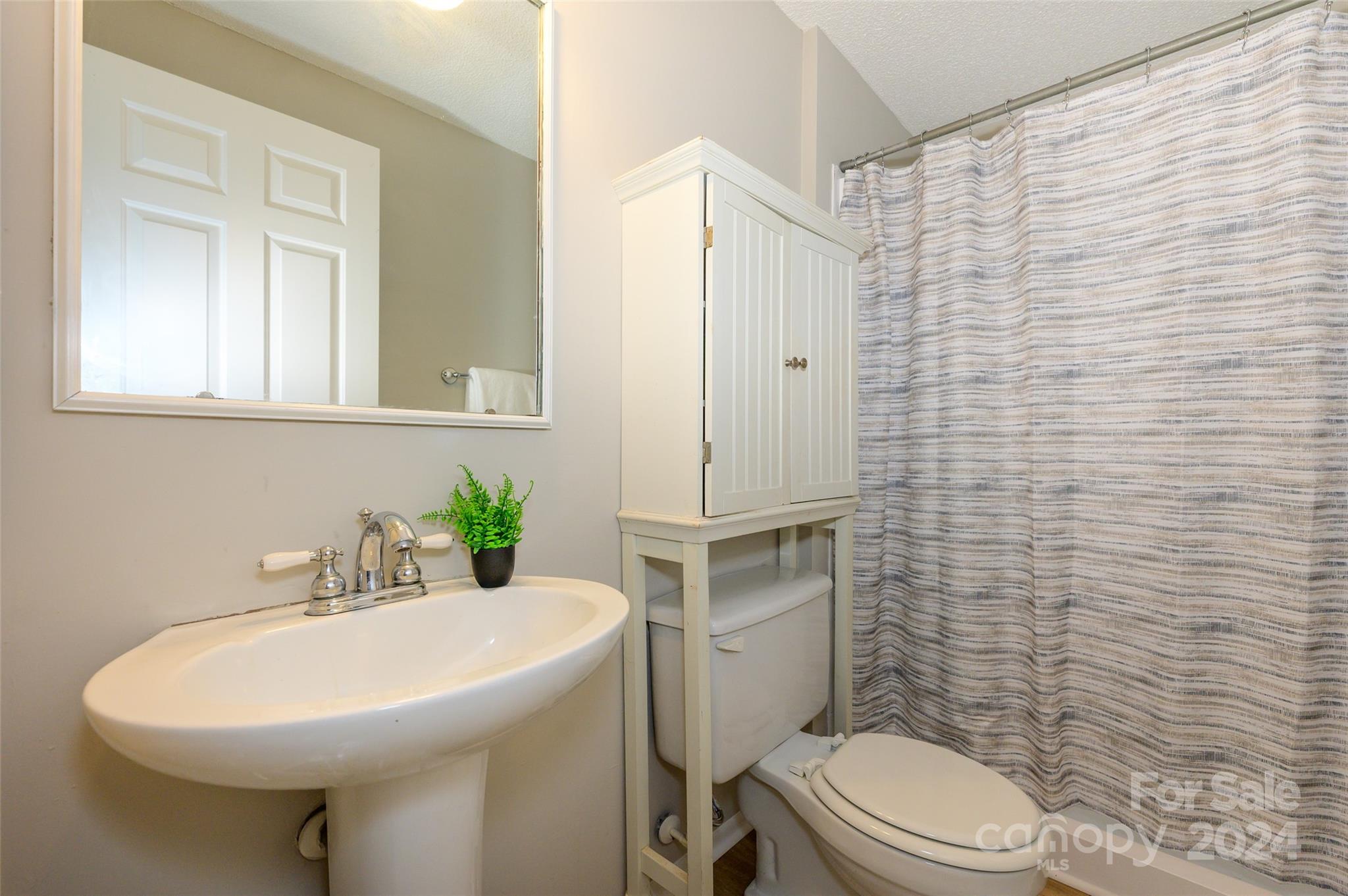 1211 Scaleybark Road, Unit B Charlotte, NC 28209 - Photo 26 of 30 a bathroom with a sink a toilet and shower