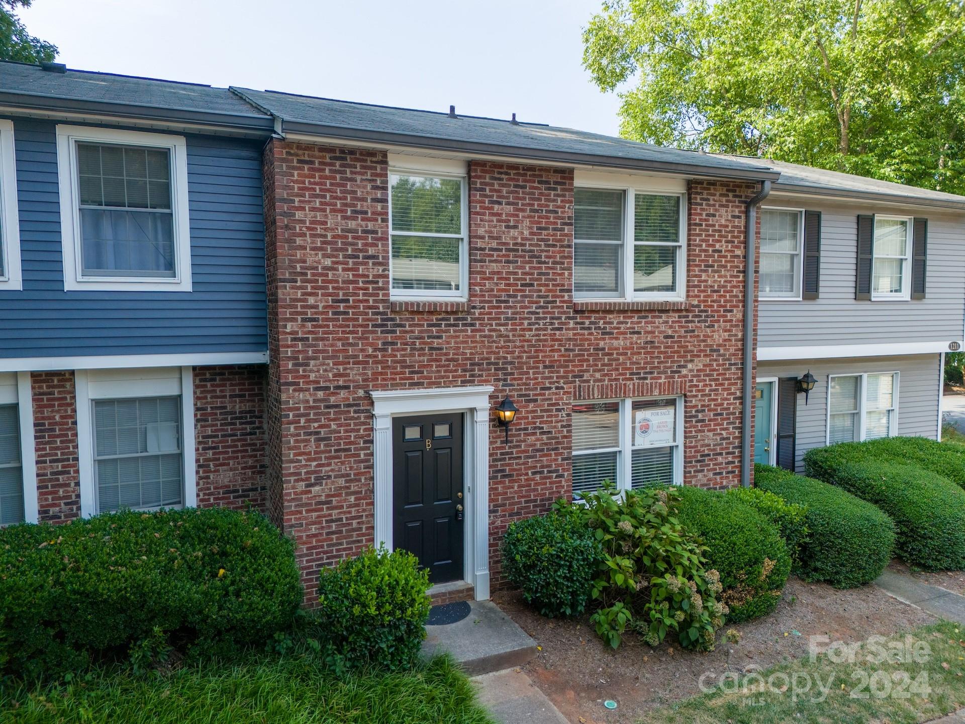 1211 Scaleybark Road, Unit B Charlotte, NC 28209 - Photo 3 of 30 a front view of a house with a yard