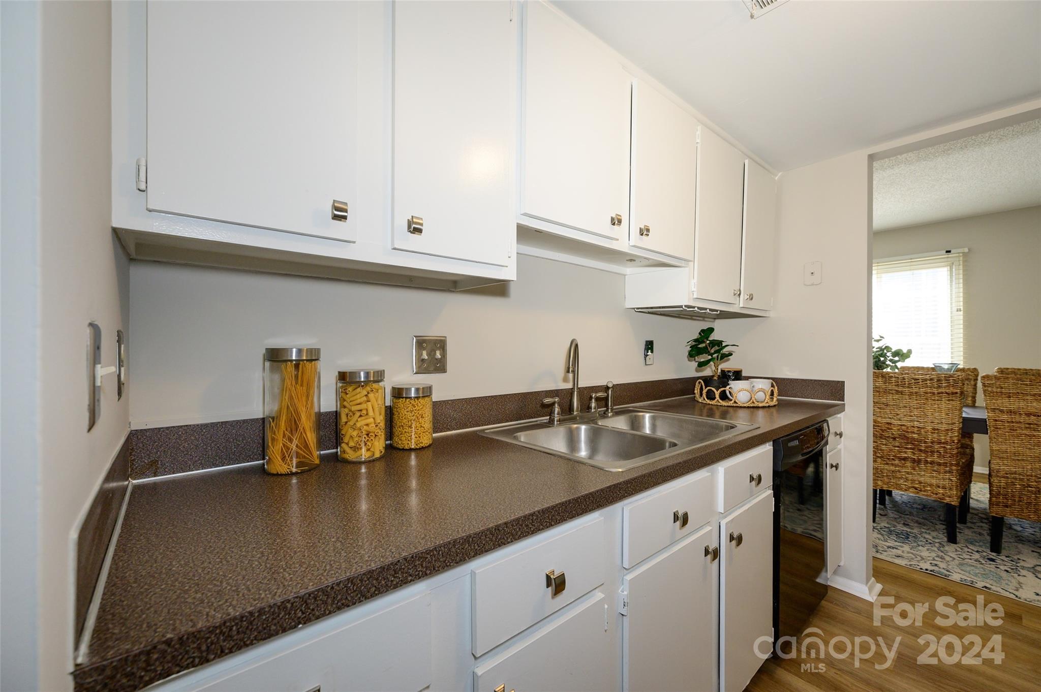 1211 Scaleybark Road, Unit B Charlotte, NC 28209 - Photo 9 of 30 a kitchen with stainless steel appliances granite countertop a sink a stove white cabinets and a granite counter tops